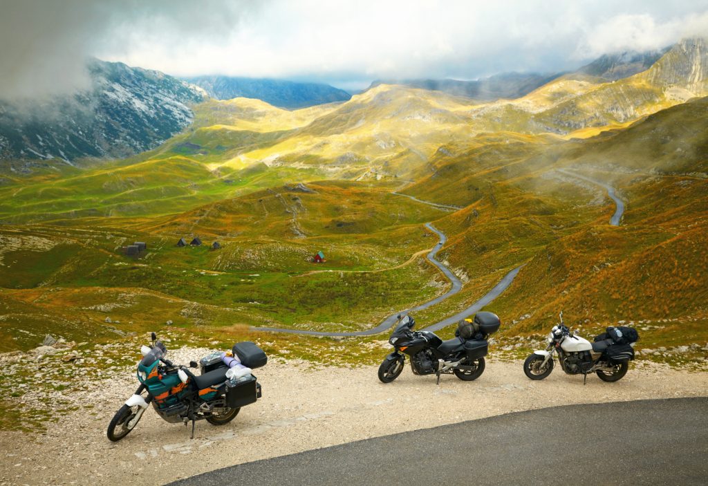 Landscape with mountain road and three motorbikes